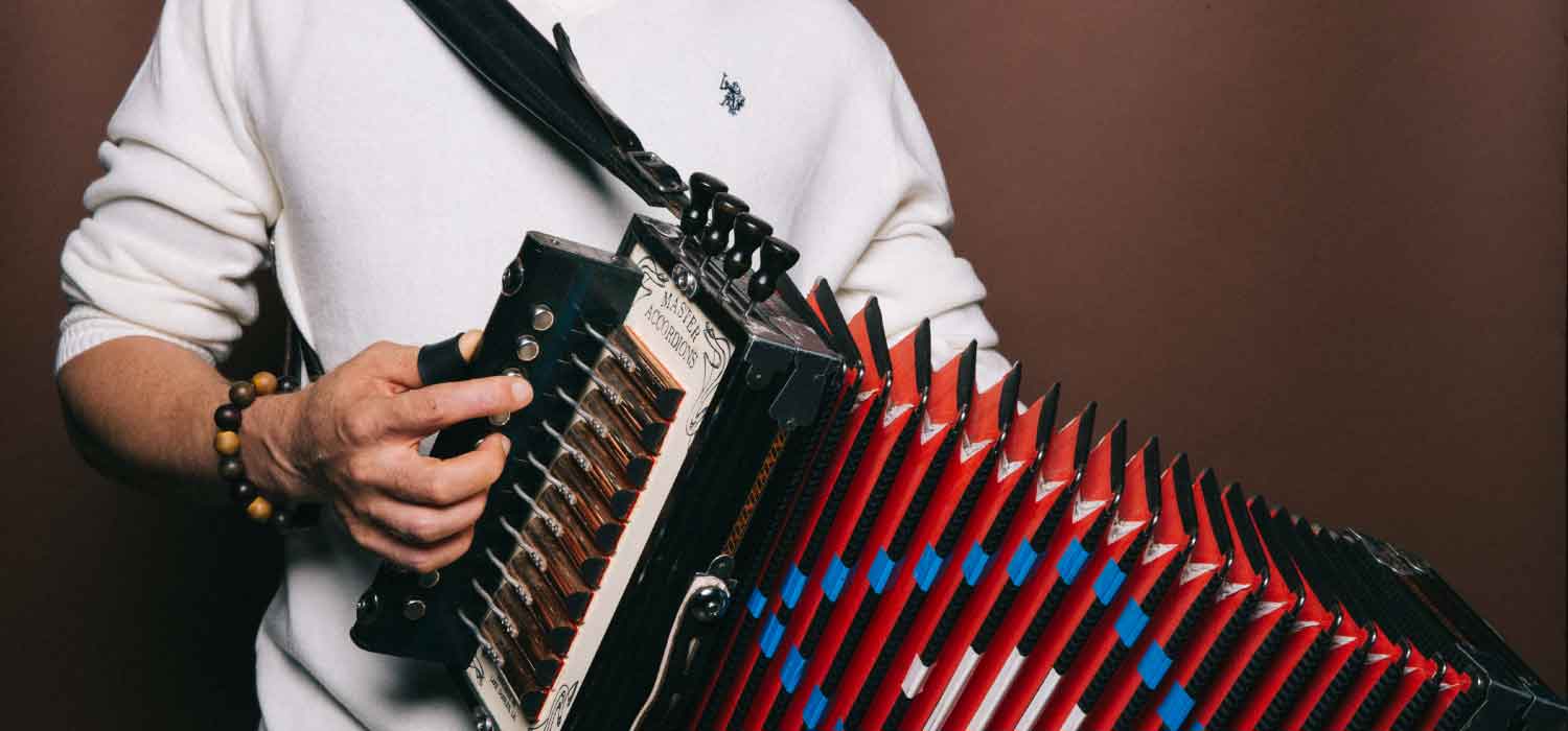 Andre Thierry holding an accordion